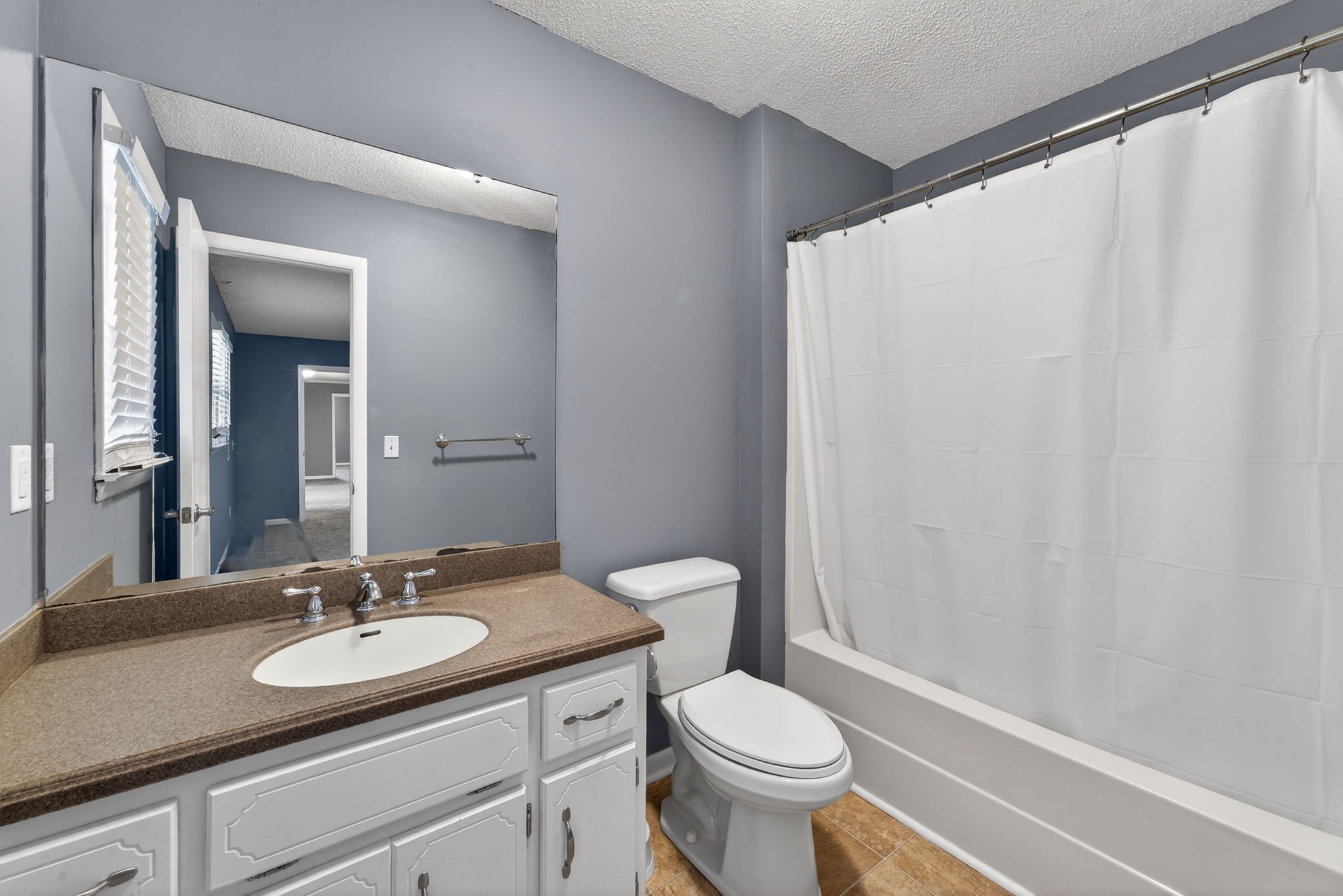232 Loop Drive Winchester, TN 37398 - Photo 19 of 41 a bathroom with a granite countertop sink toilet and a mirror
