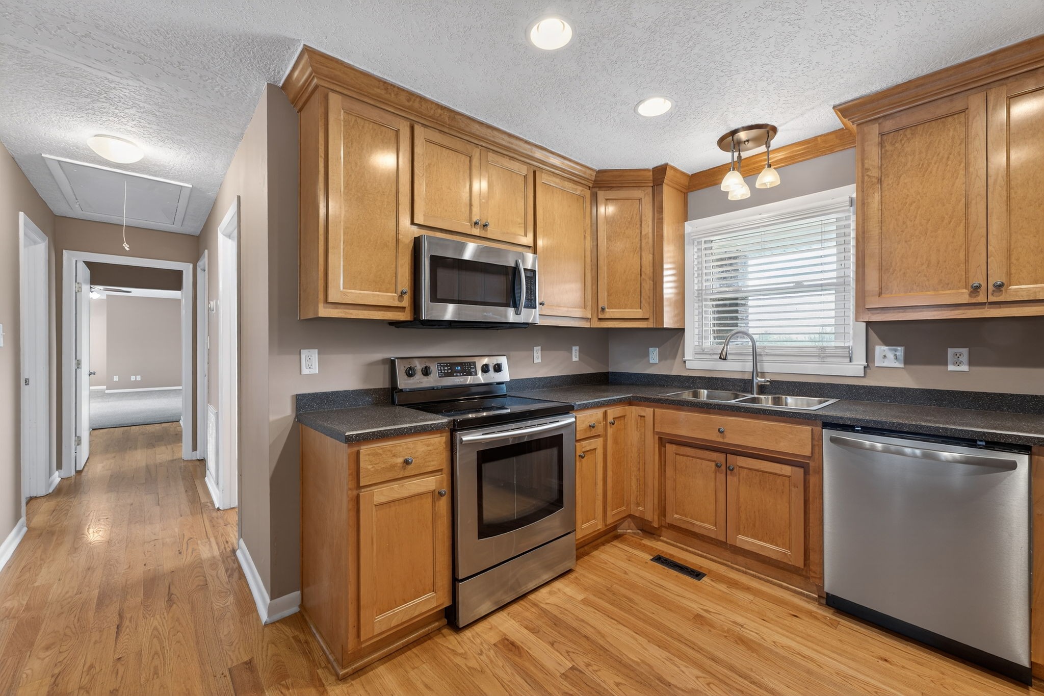 232 Loop Drive Winchester, TN 37398 - Photo 10 of 41 a kitchen with stainless steel appliances granite countertop a stove a sink and a microwave