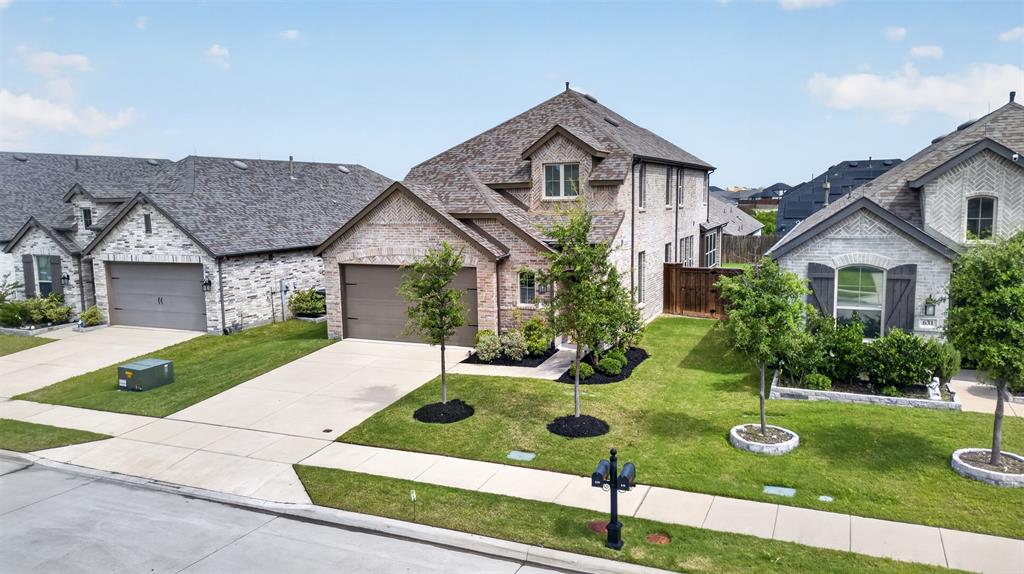 629 Claverton Lane Forney, TX 75126 - Photo 2 of 33 a front view of a house with garden