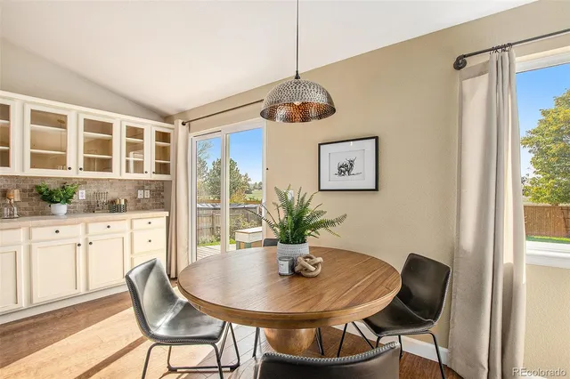a view of a dining room with furniture window and outside view