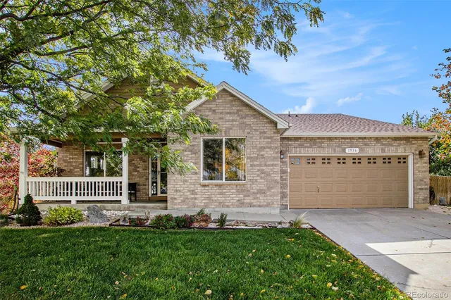 a front view of a house with a garden and yard