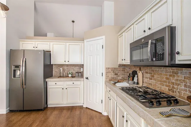 a kitchen with stainless steel appliances granite countertop a stove and a refrigerator