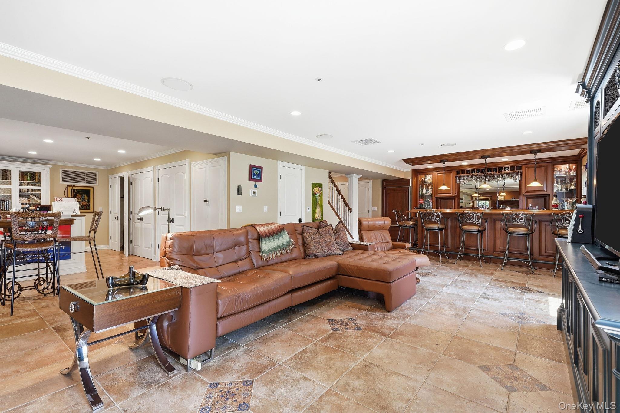 33 Hevelyne Road Elmsford, NY 10523 - Photo 31 of 43 Family room with gas fireplace in terrace level with Bar and walk-out access to patio.