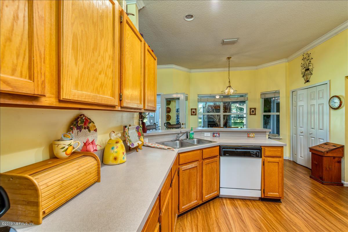 1372 Blackmon Road Green Cove Springs, FL 32043 - Photo 11 of 26 a kitchen with stainless steel appliances granite countertop a stove and a wooden floors