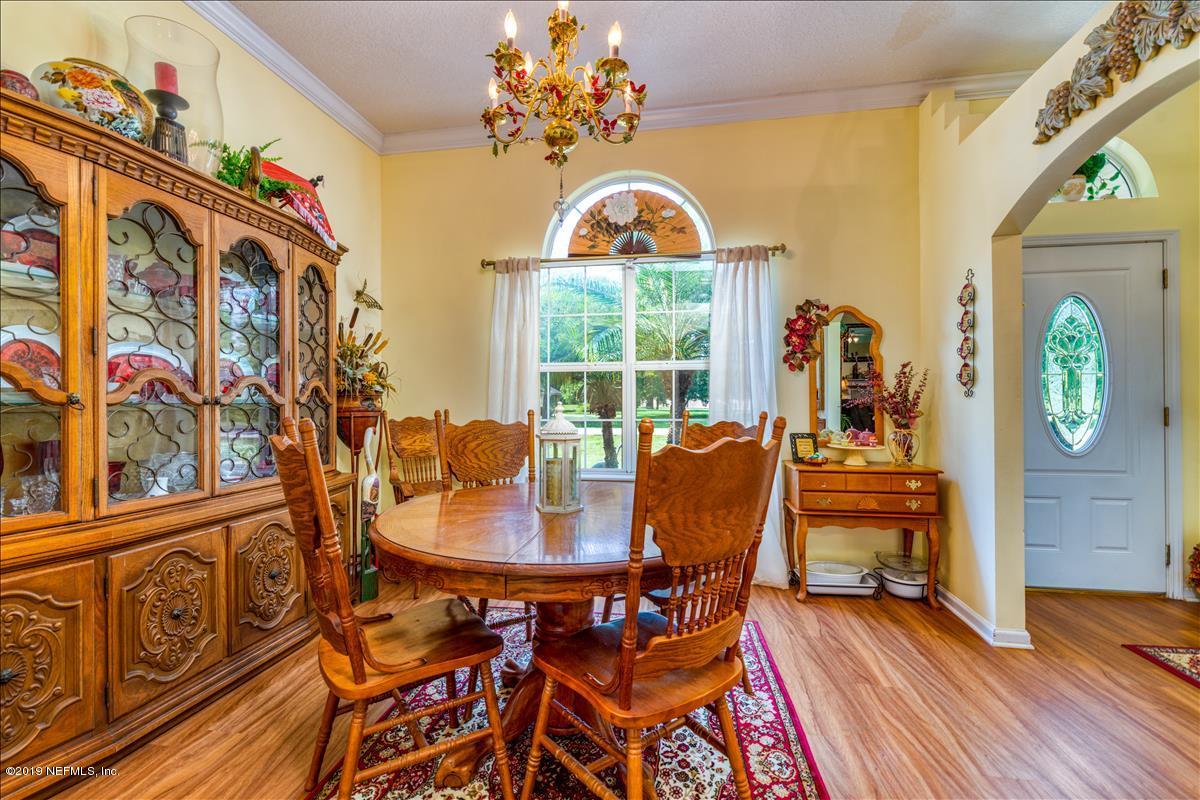 1372 Blackmon Road Green Cove Springs, FL 32043 - Photo 14 of 26 a view of a dining room with furniture window and wooden floor