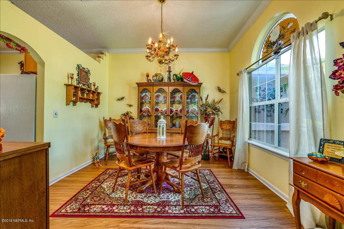 1372 Blackmon Road Green Cove Springs, FL 32043 - Photo 15 of 26 a view of a dining room with furniture and a chandelier