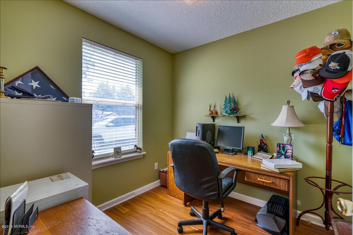 1372 Blackmon Road Green Cove Springs, FL 32043 - Photo 17 of 26 a view of a workspace with furniture and a window