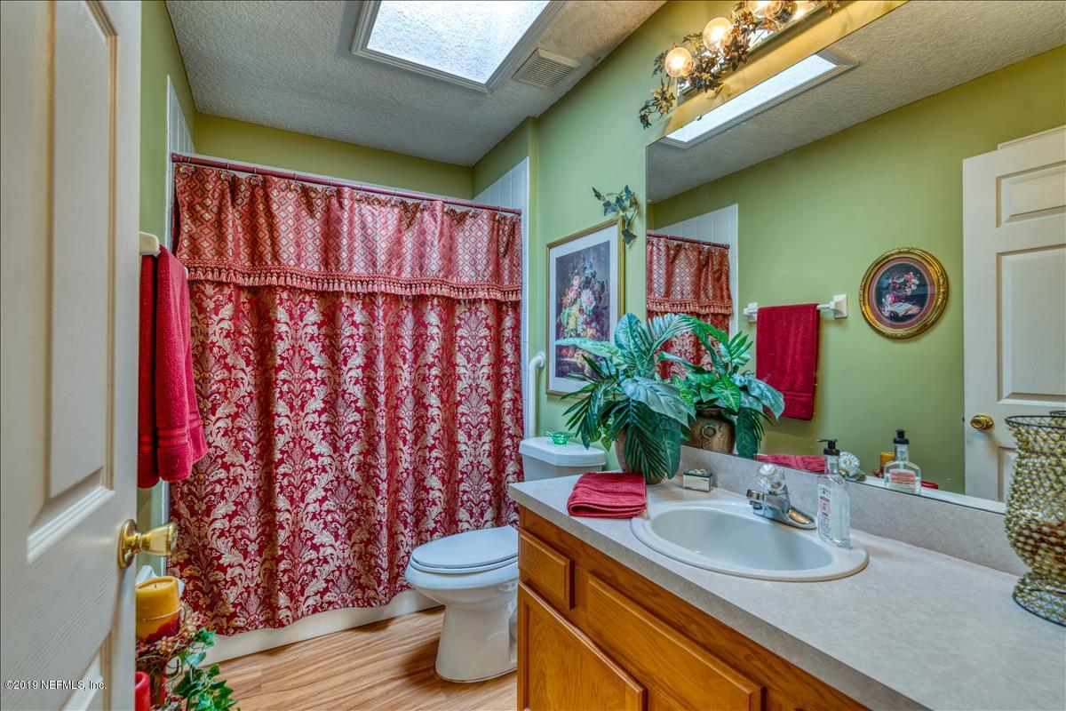 1372 Blackmon Road Green Cove Springs, FL 32043 - Photo 21 of 26 a bathroom with a sink toilet and a shower