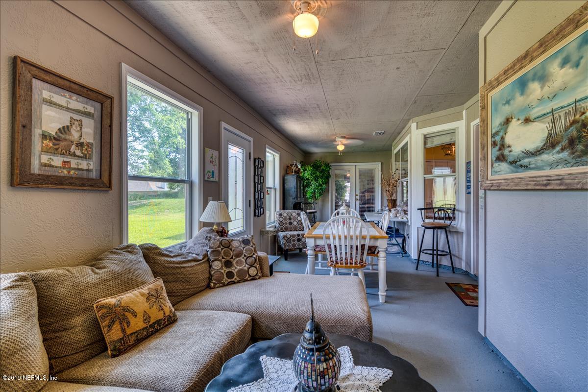 1372 Blackmon Road Green Cove Springs, FL 32043 - Photo 22 of 26 a living room with furniture and a large window