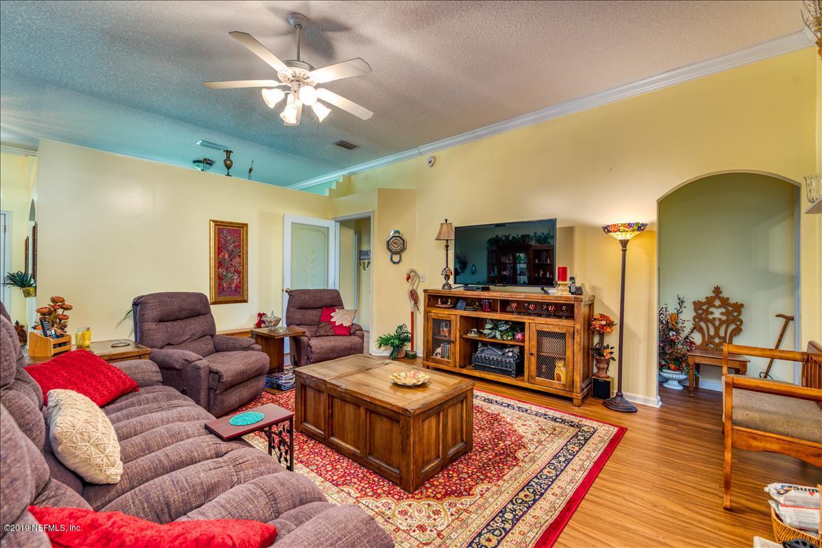 1372 Blackmon Road Green Cove Springs, FL 32043 - Photo 8 of 26 a living room with furniture and a flat screen tv