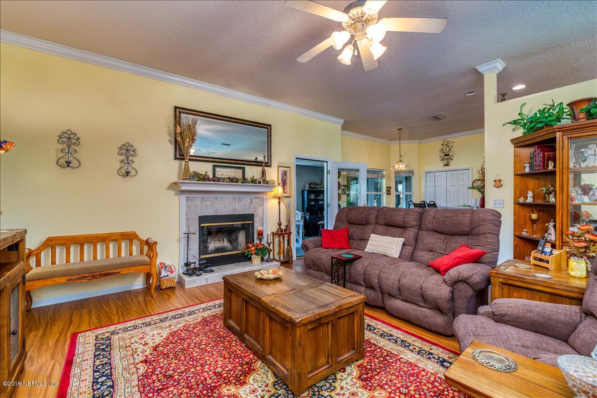 1372 Blackmon Road Green Cove Springs, FL 32043 - Photo 9 of 26 a living room with furniture and a fireplace