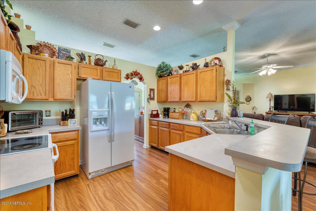 1372 Blackmon Road Green Cove Springs, FL 32043 - Photo 10 of 26 a kitchen with stainless steel appliances granite countertop a refrigerator a stove and a wooden floors