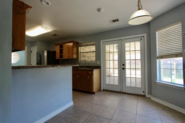 a kitchen with granite countertop a sink and a cabinets