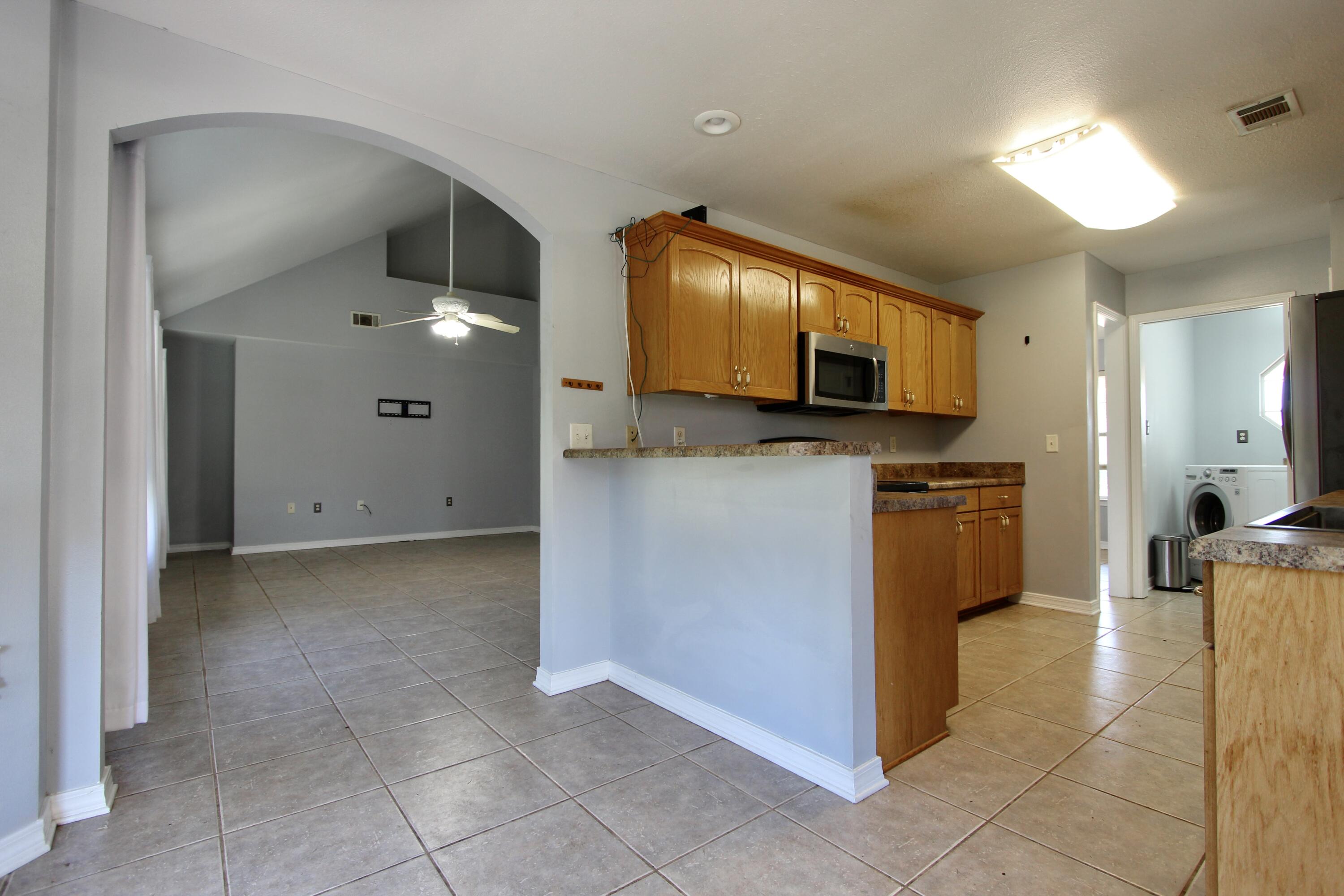 6064 Buckward Road Baker, FL 32531 - Photo 13 of 34 a kitchen with granite countertop a sink and a cabinets