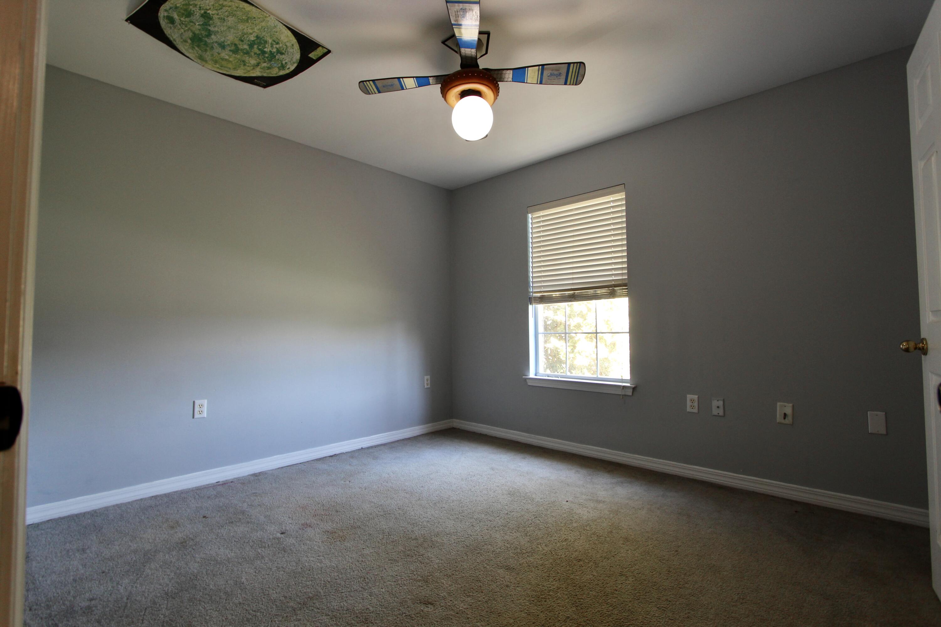 6064 Buckward Road Baker, FL 32531 - Photo 18 of 34 an empty room with windows and fan