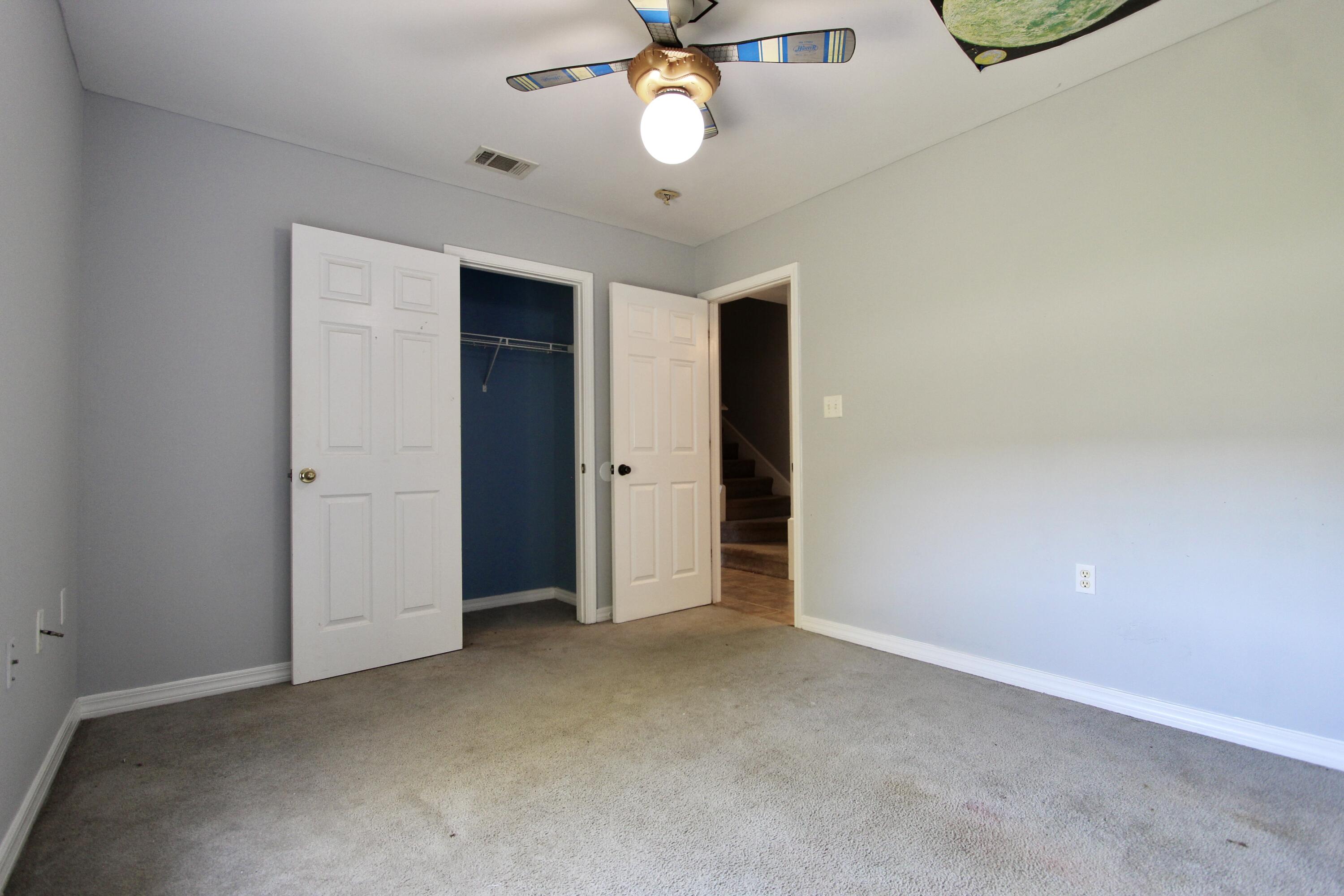 6064 Buckward Road Baker, FL 32531 - Photo 20 of 34 an empty room with closet and windows