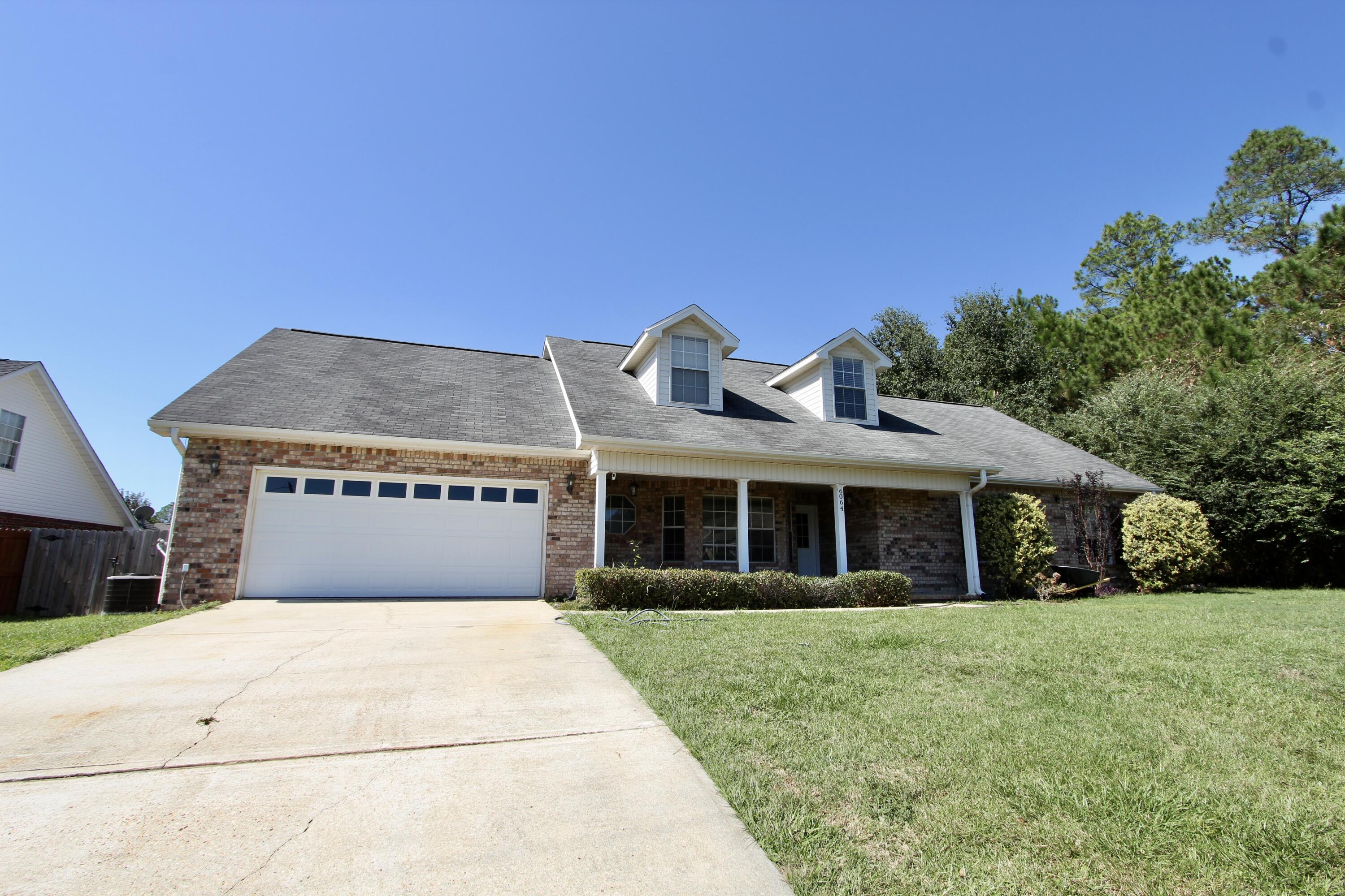 6064 Buckward Road Baker, FL 32531 - Photo 2 of 34 a front view of a house with a garden