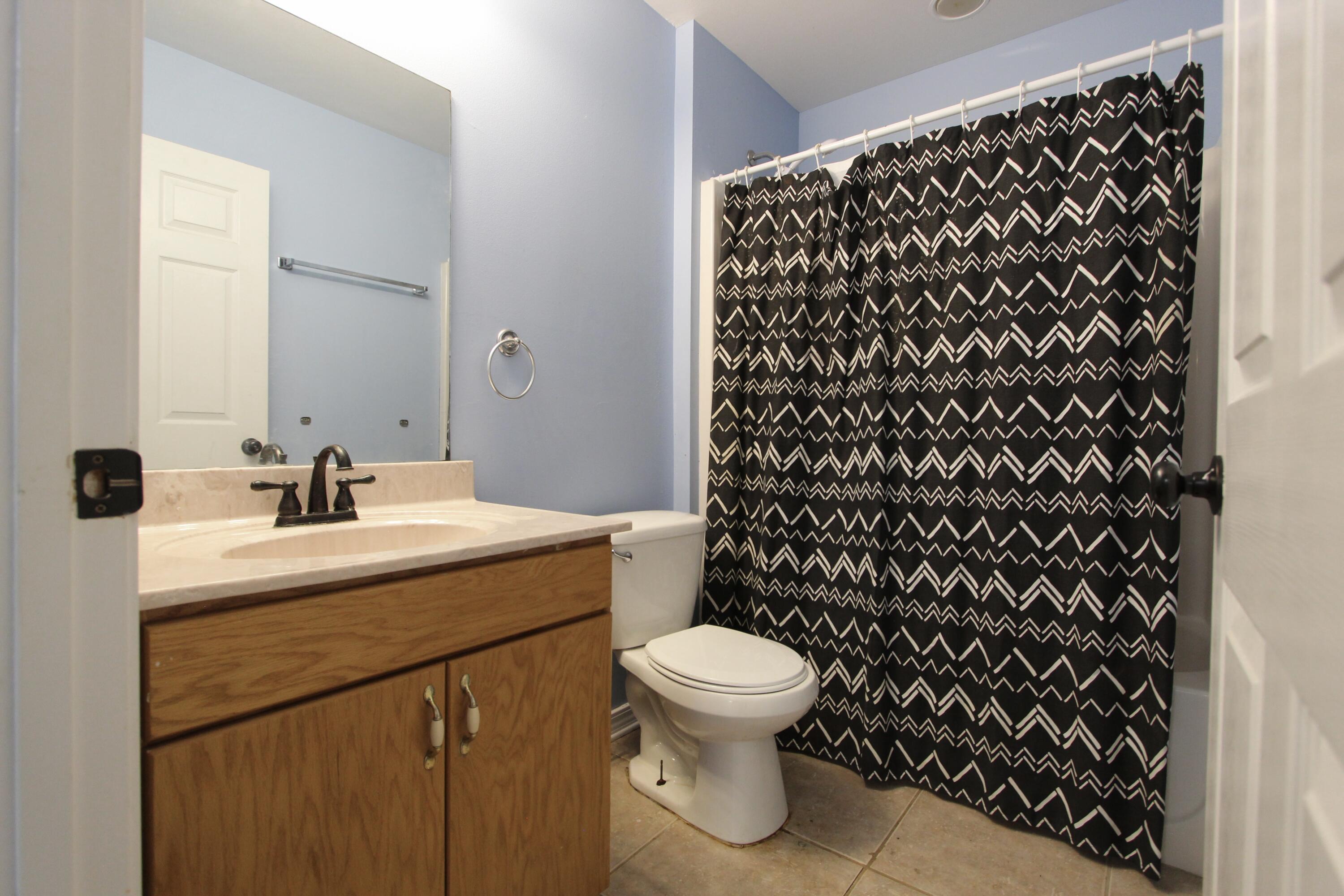 6064 Buckward Road Baker, FL 32531 - Photo 21 of 34 a bathroom with a sink toilet and shower