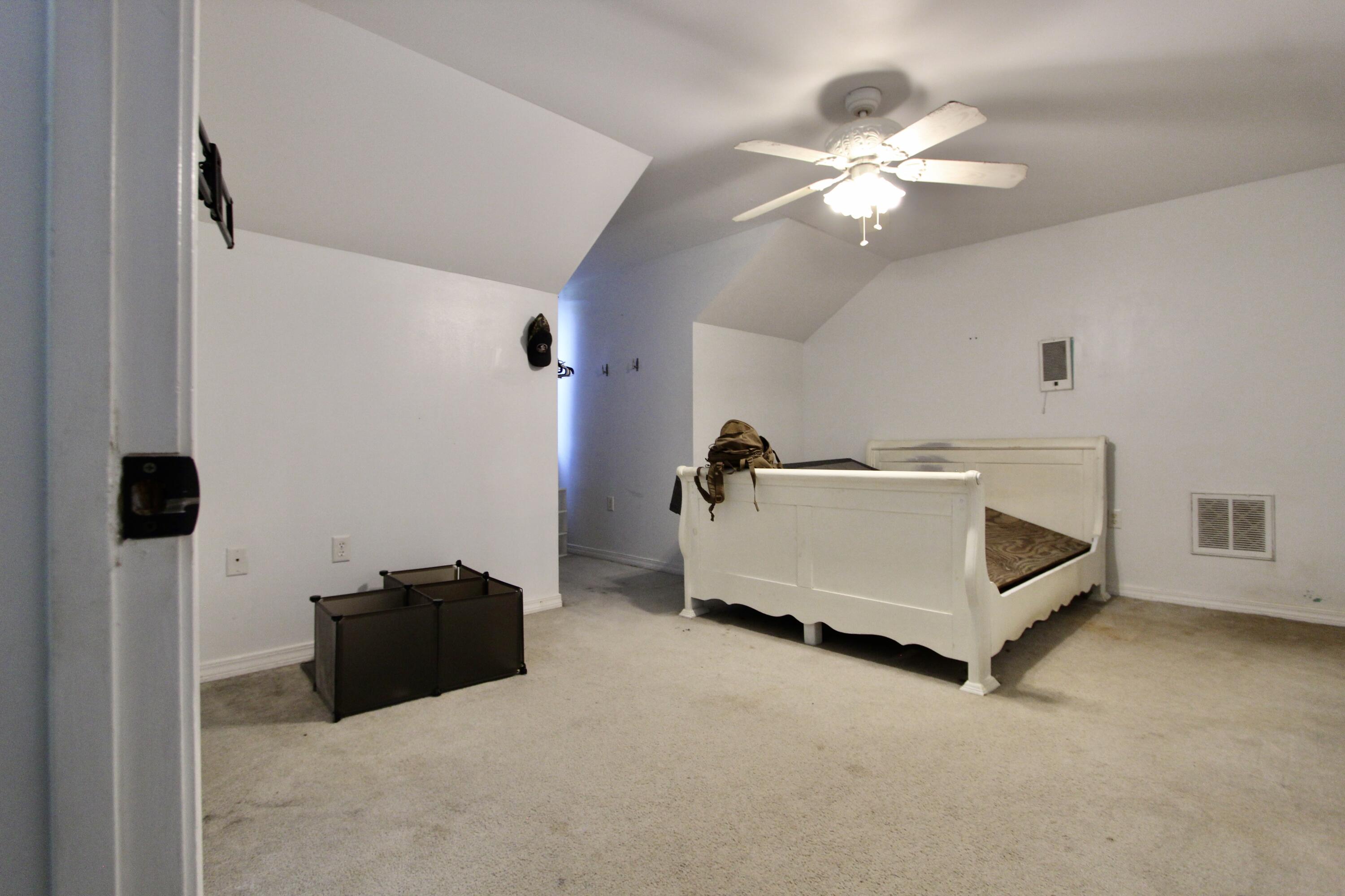 6064 Buckward Road Baker, FL 32531 - Photo 26 of 34 a spacious bedroom with a bed and a chandelier