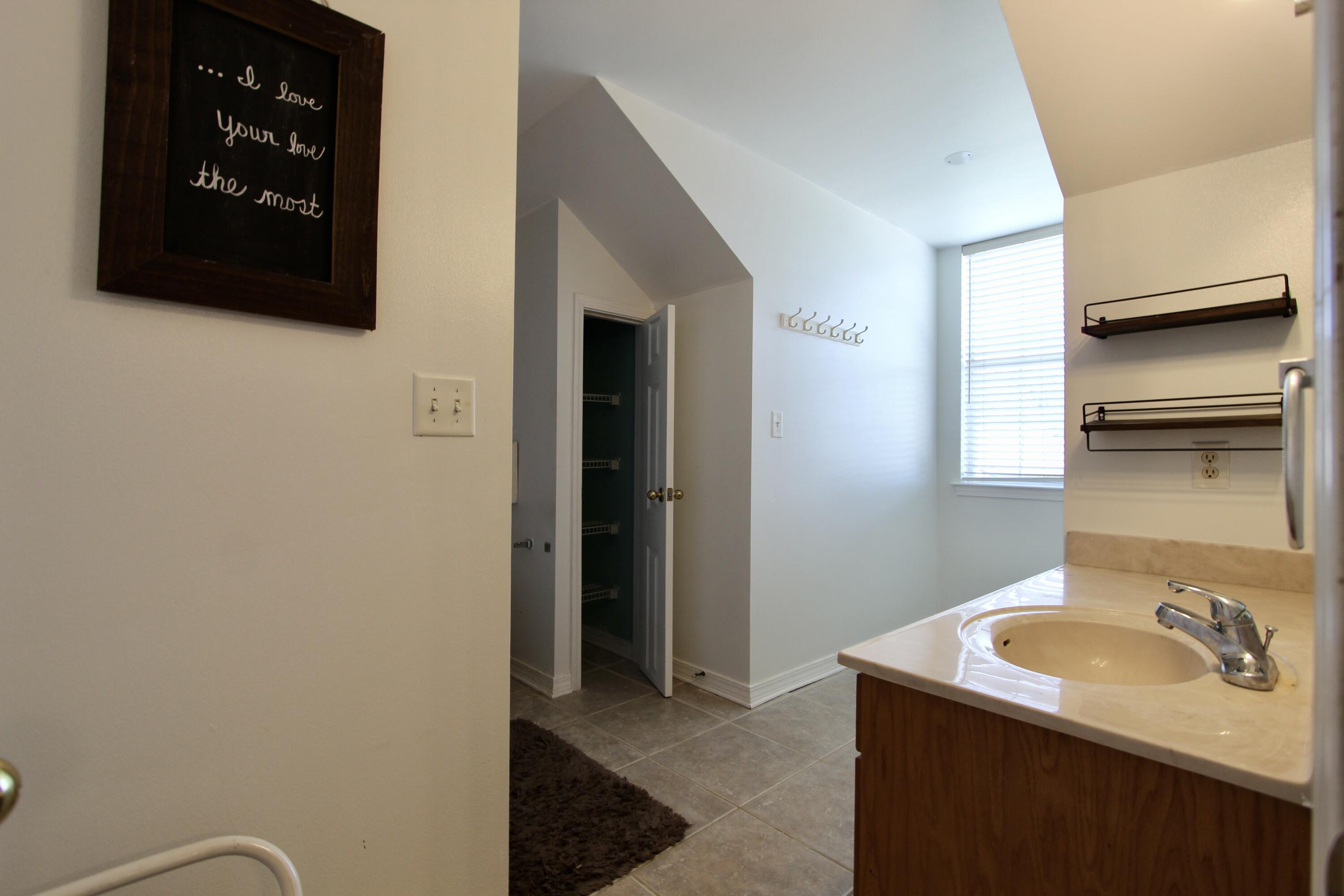 6064 Buckward Road Baker, FL 32531 - Photo 28 of 34 a bathroom with a sink and a mirror