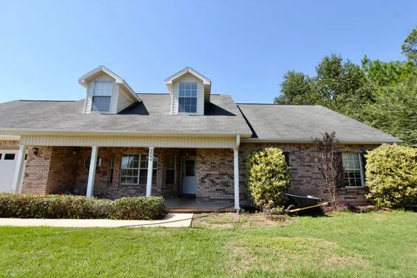 a view of a house with garden and plants