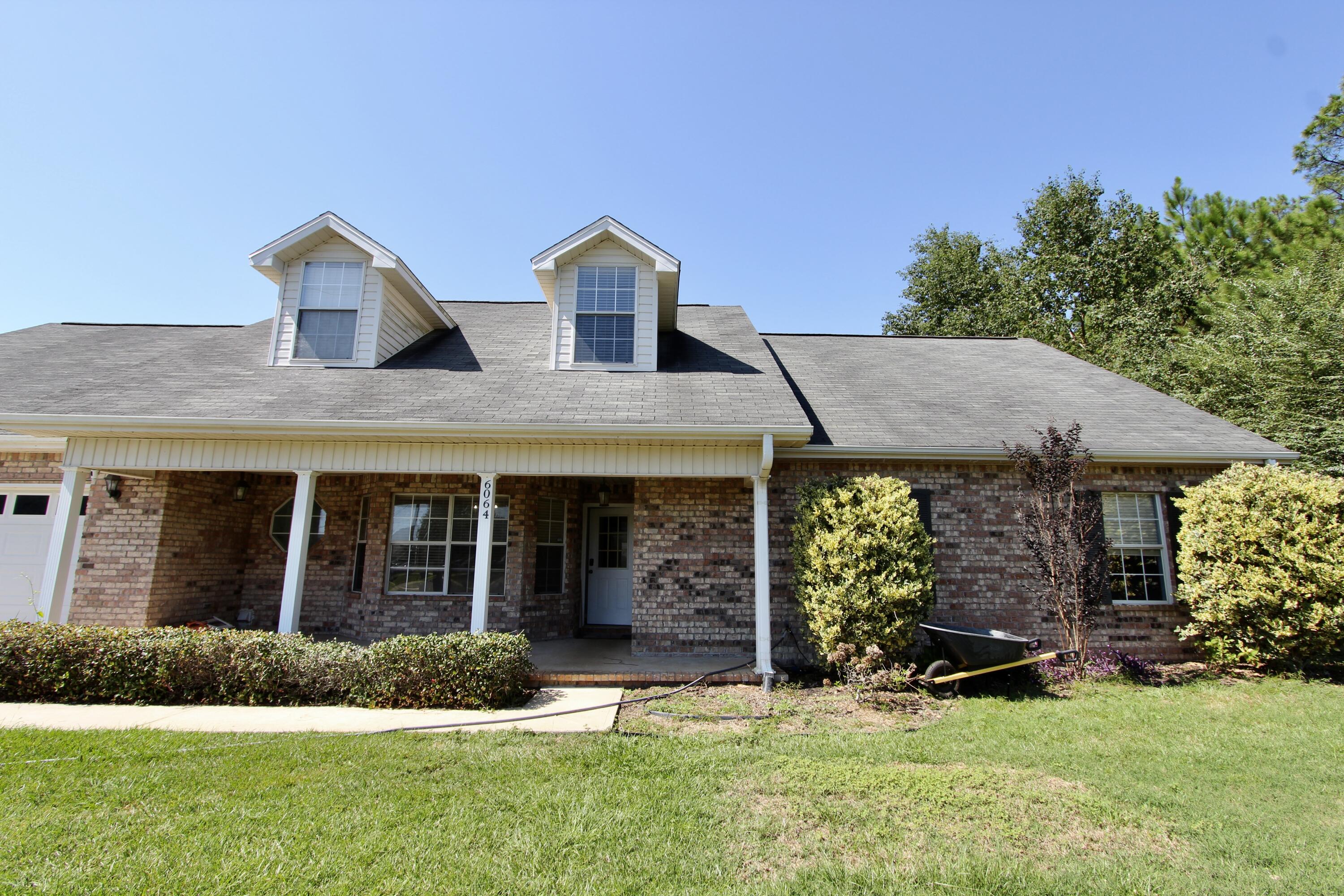 6064 Buckward Road Baker, FL 32531 - Photo 3 of 34 a view of a house with garden and plants