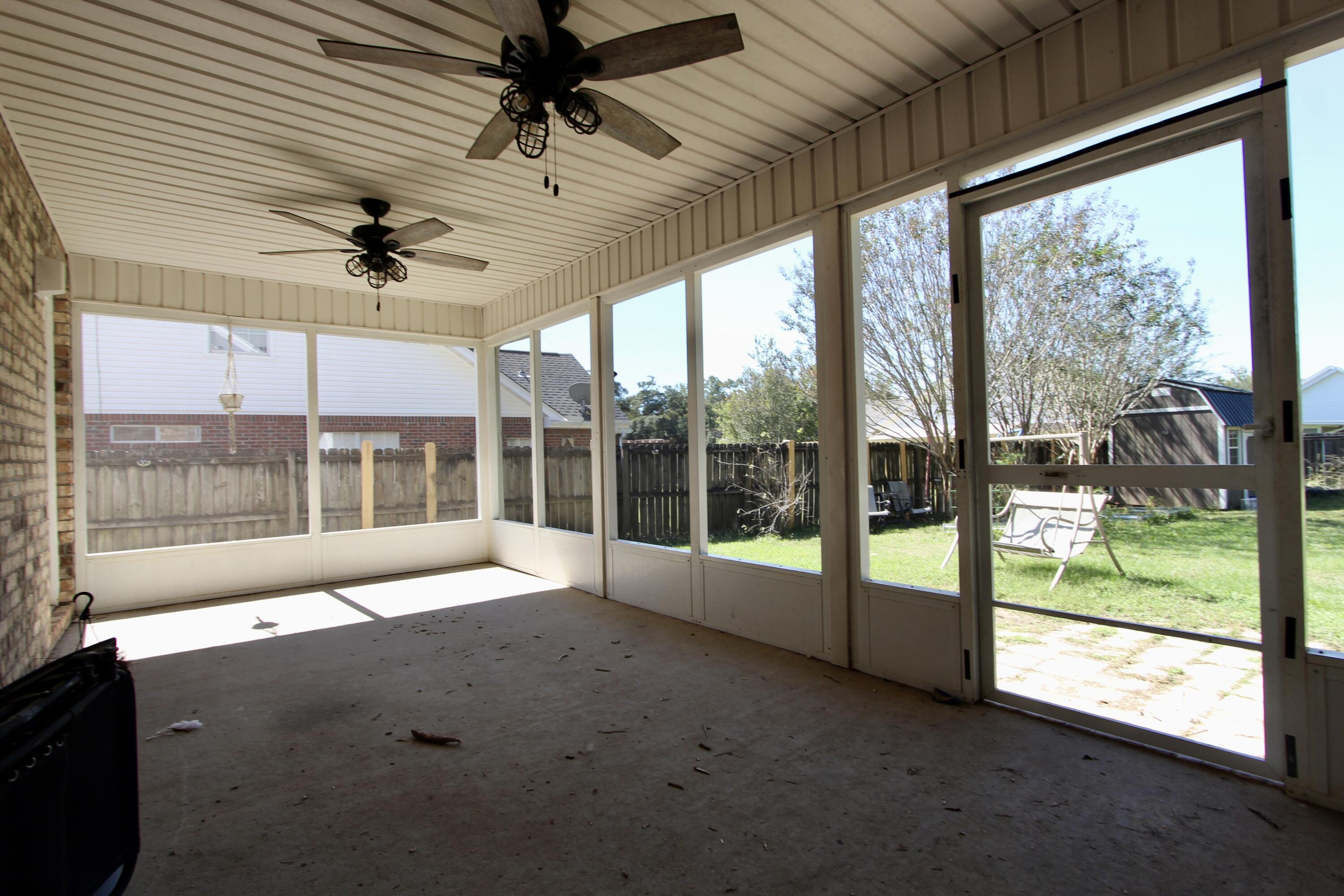 6064 Buckward Road Baker, FL 32531 - Photo 31 of 34 a view of an empty room with windows and a ceiling fan