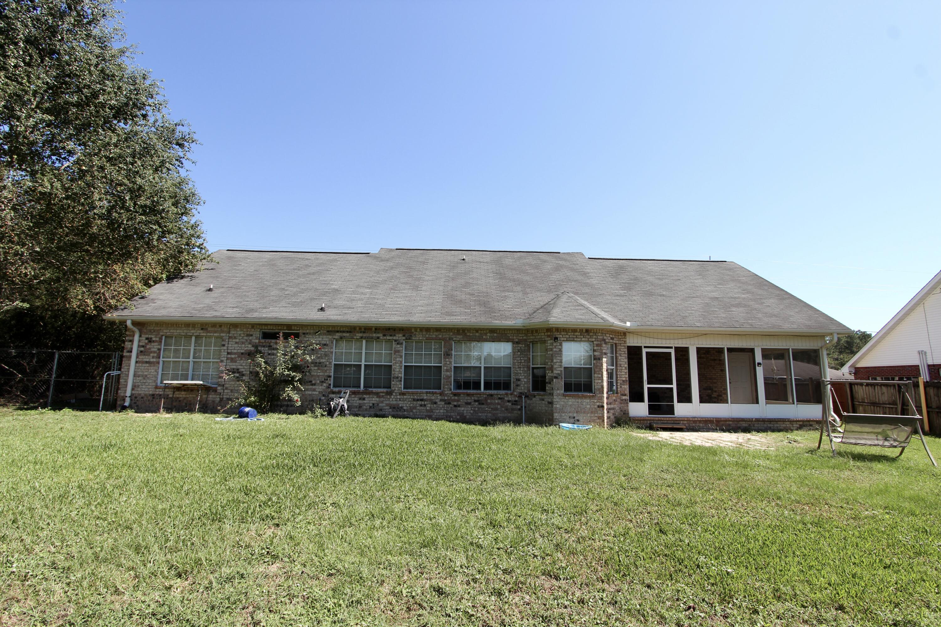 6064 Buckward Road Baker, FL 32531 - Photo 32 of 34 a front view of a house with a yard table and chairs