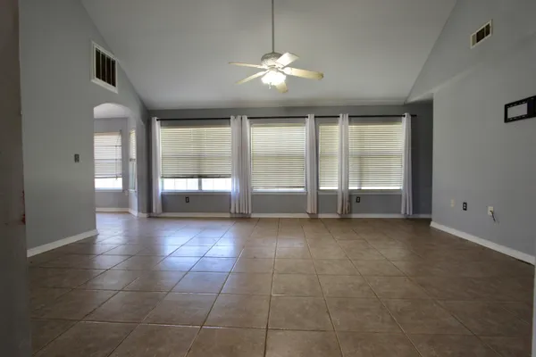 a kitchen with granite countertop a stove a sink and a microwave