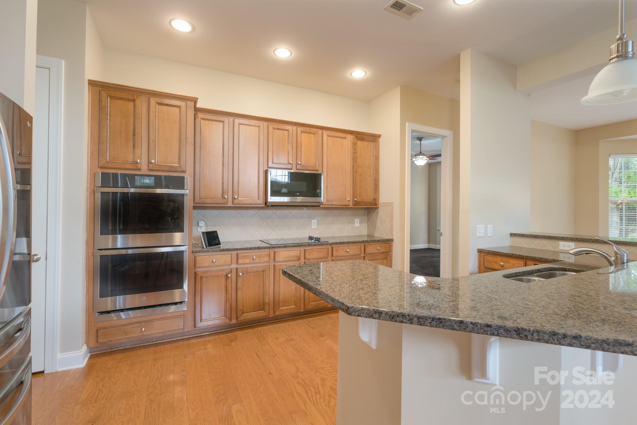 1385 Secret Path Drive Fort Mill, SC 29708 - Photo 18 of 48 a kitchen with stainless steel appliances granite countertop a sink and a microwave