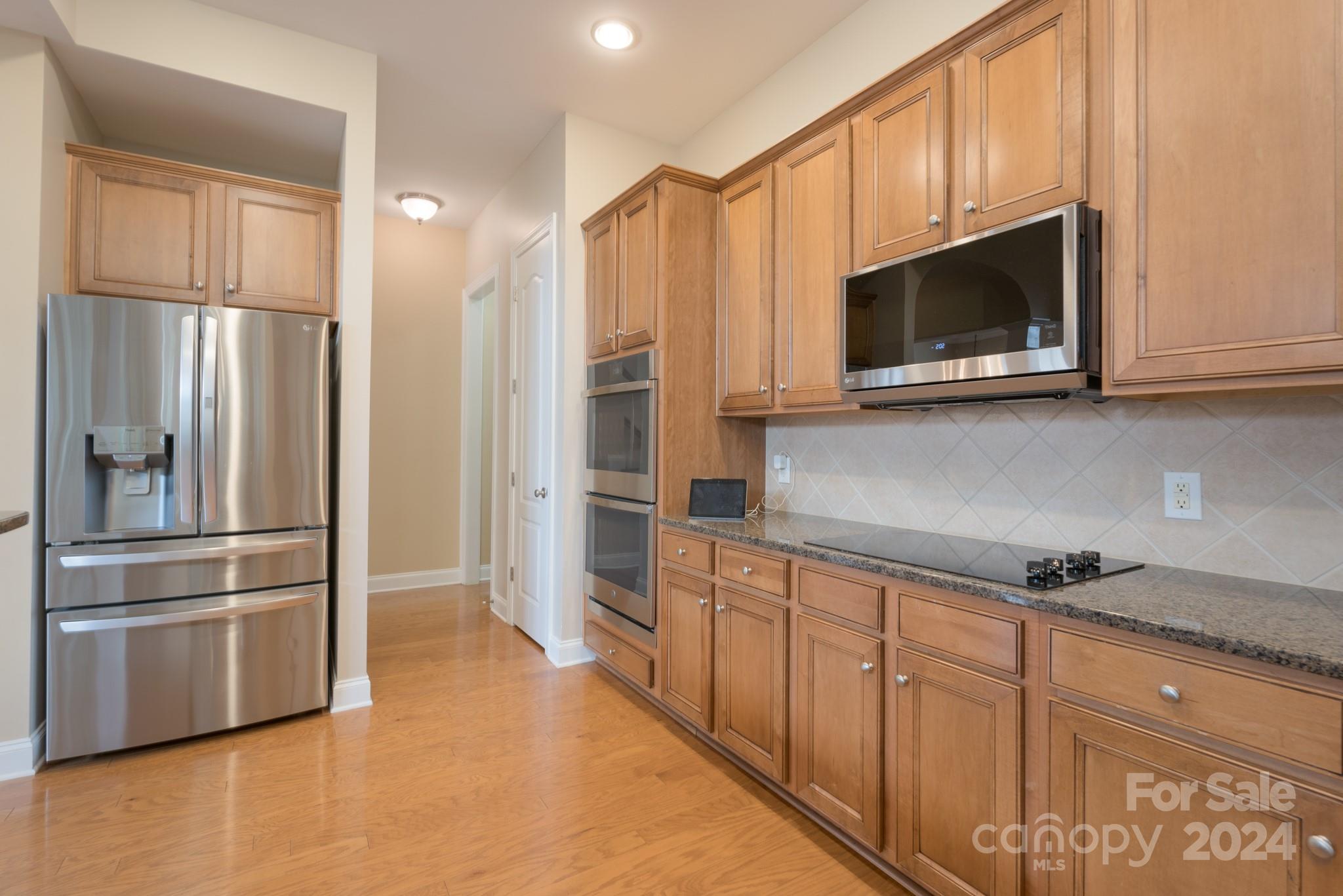 1385 Secret Path Drive Fort Mill, SC 29708 - Photo 20 of 48 a kitchen with stainless steel appliances granite countertop a refrigerator a microwave a sink and cabinets