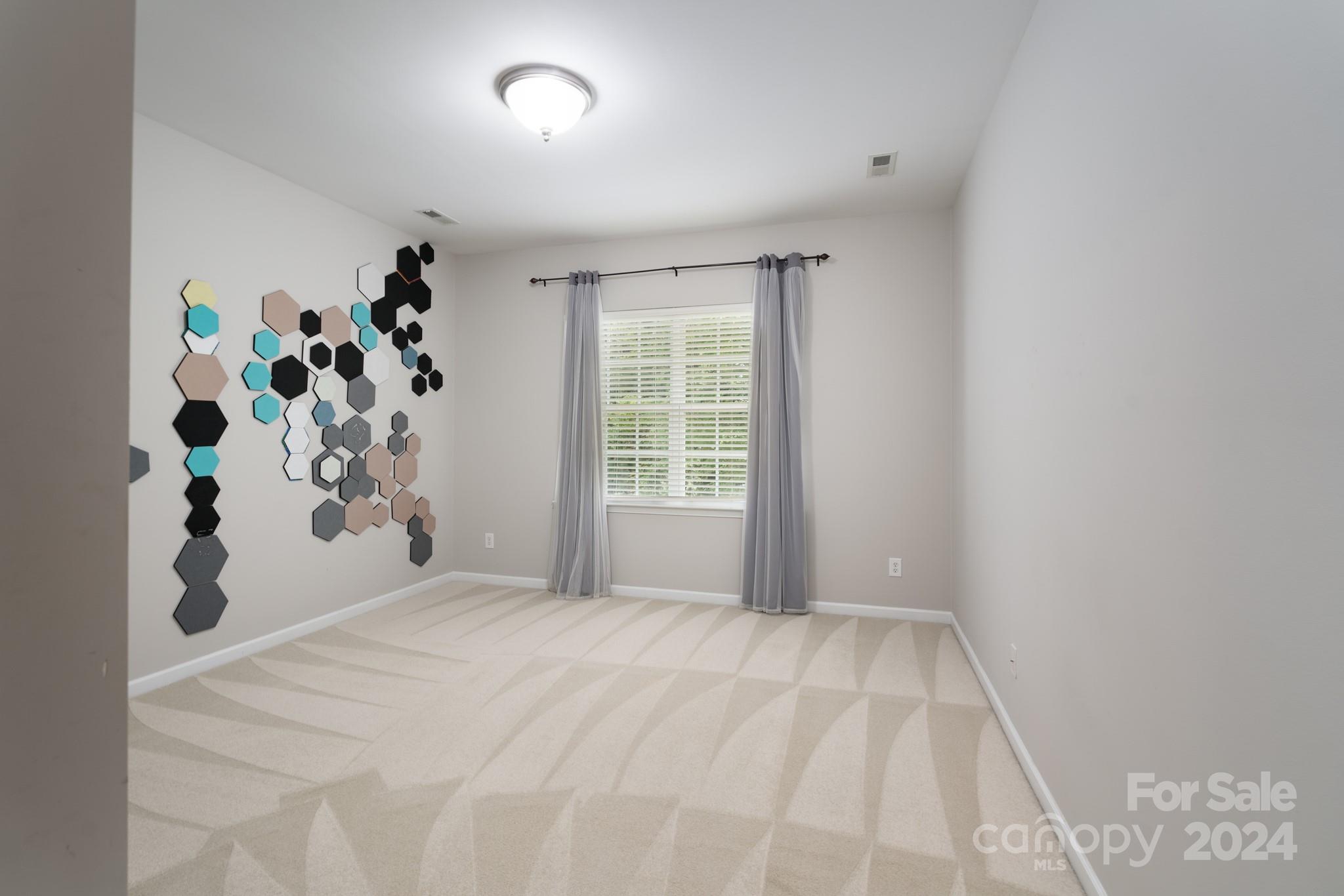 1385 Secret Path Drive Fort Mill, SC 29708 - Photo 32 of 48 a view of a bedroom with window and flower pot