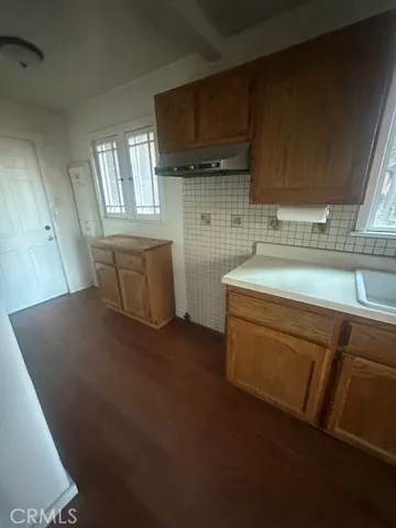 a kitchen with stainless steel appliances kitchen island granite countertop a sink window and cabinets