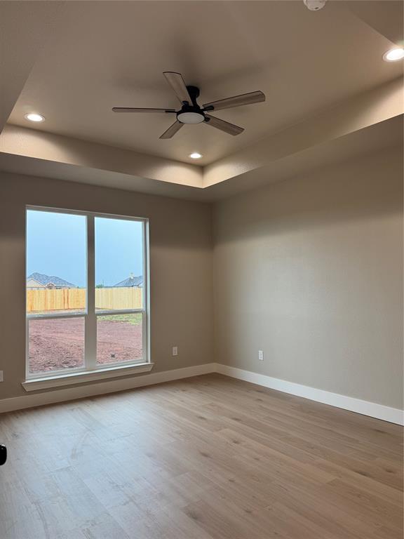 143 Ridge Road Tuscola, TX 79562 - Photo 10 of 24 an empty room with wooden floor and windows