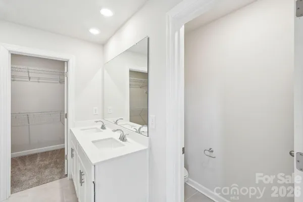 a bathroom with a sink a mirror and a shower