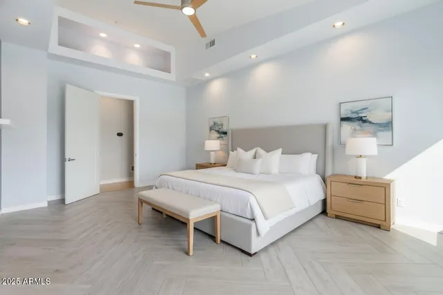 an empty room with a window and a fan