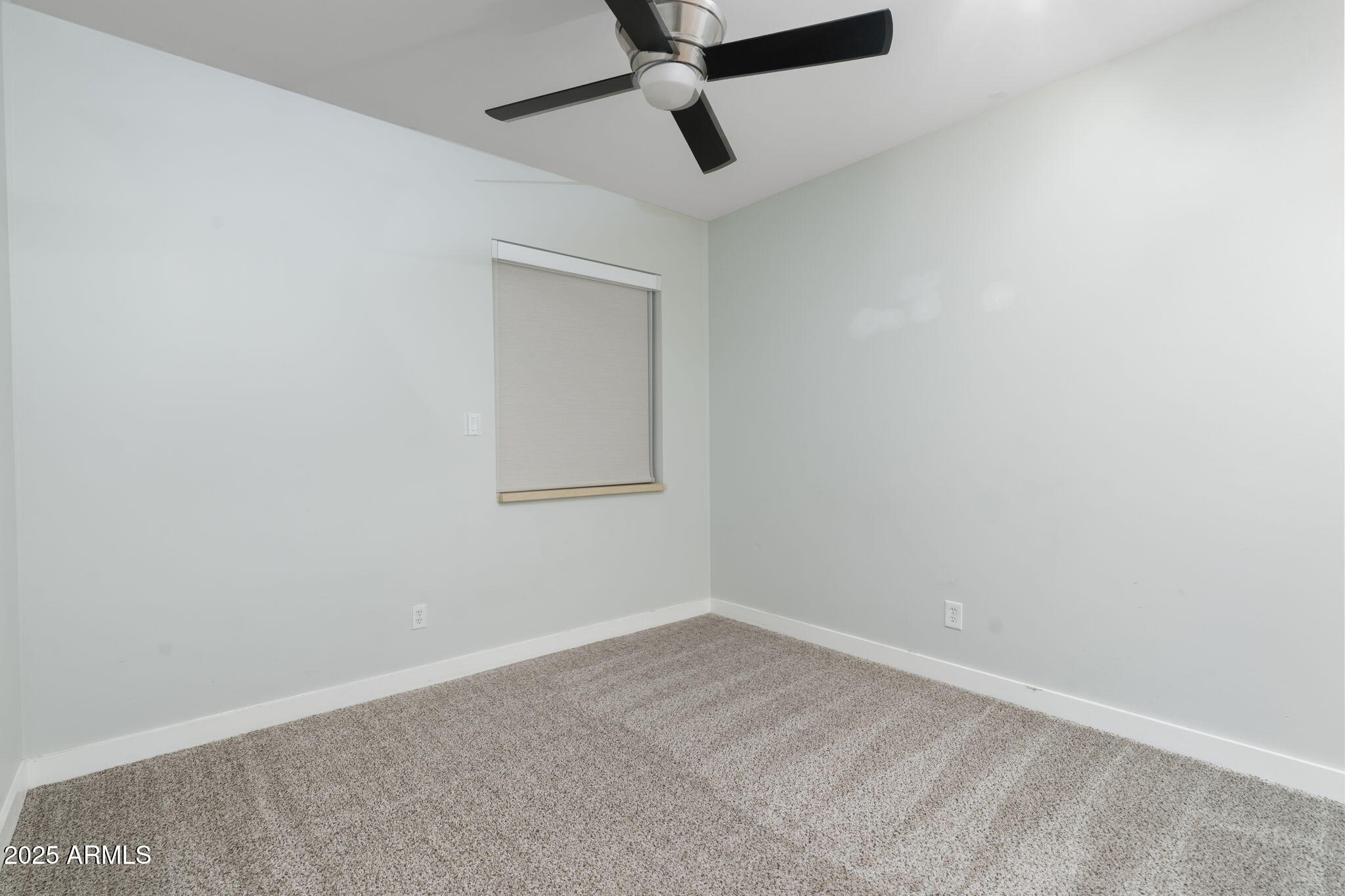 9433 South Stanley Place Tempe, AZ 85284 - Photo 35 of 47 an empty room with a window and a fan