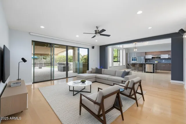 a living room with a couch and a view of kitchen