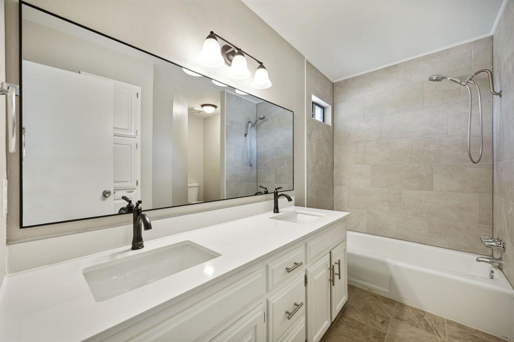2420 Lakeview Circle McKinney, TX 75072 - Photo 11 of 25 a bathroom with a sink a toilet a mirror and shower