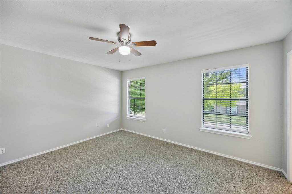 2420 Lakeview Circle McKinney, TX 75072 - Photo 14 of 25 an empty room with a window and a fan