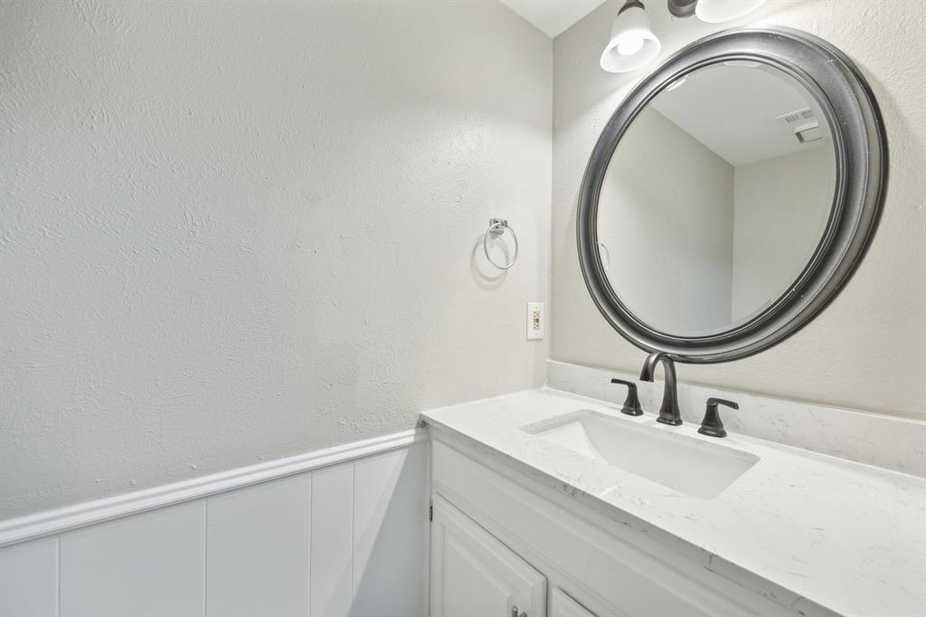 2420 Lakeview Circle McKinney, TX 75072 - Photo 16 of 25 a bathroom with a sink and a mirror