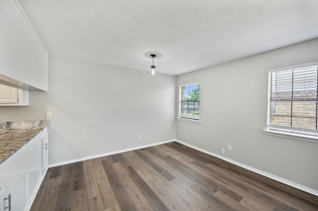 2420 Lakeview Circle McKinney, TX 75072 - Photo 18 of 25 wooden floor in an empty room with a window