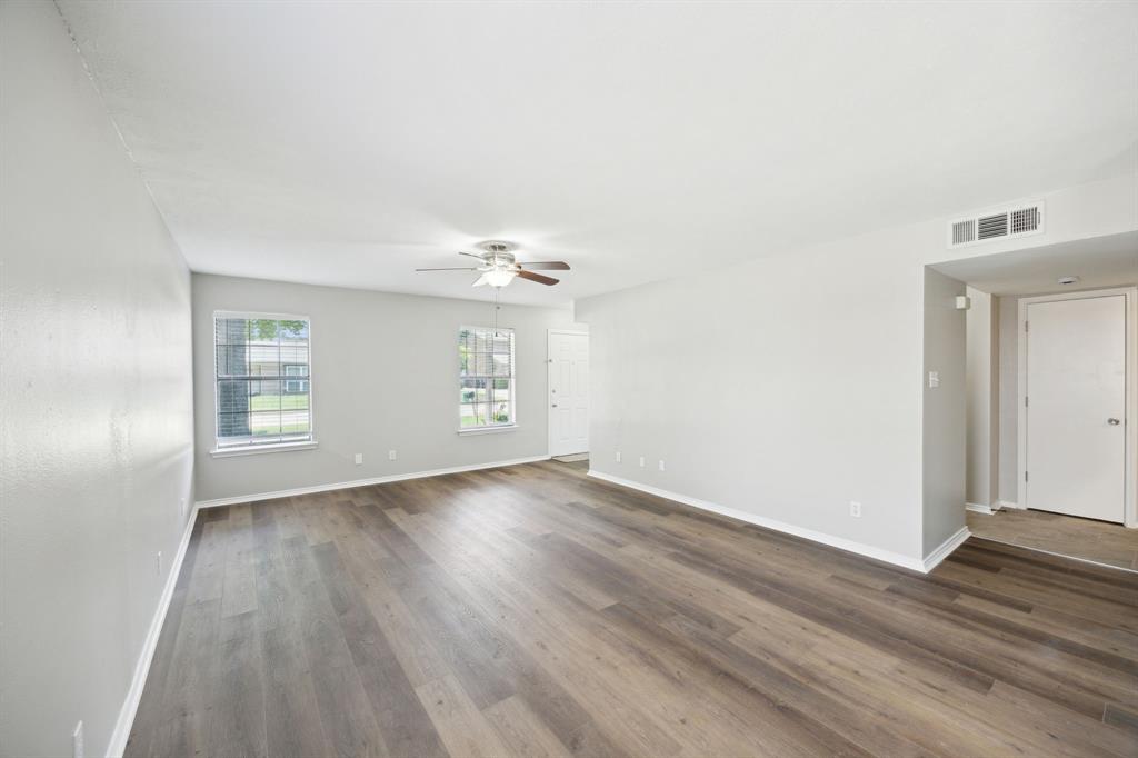2420 Lakeview Circle McKinney, TX 75072 - Photo 20 of 25 an empty room with wooden floor and windows