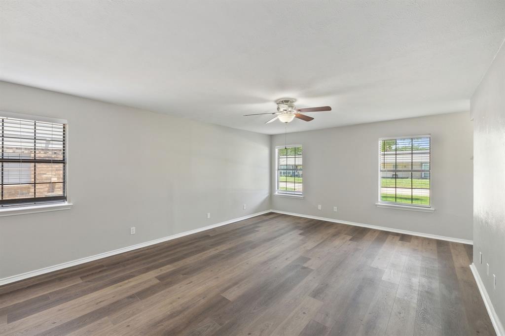 2420 Lakeview Circle McKinney, TX 75072 - Photo 21 of 25 a view of an empty room with a window and wooden floor