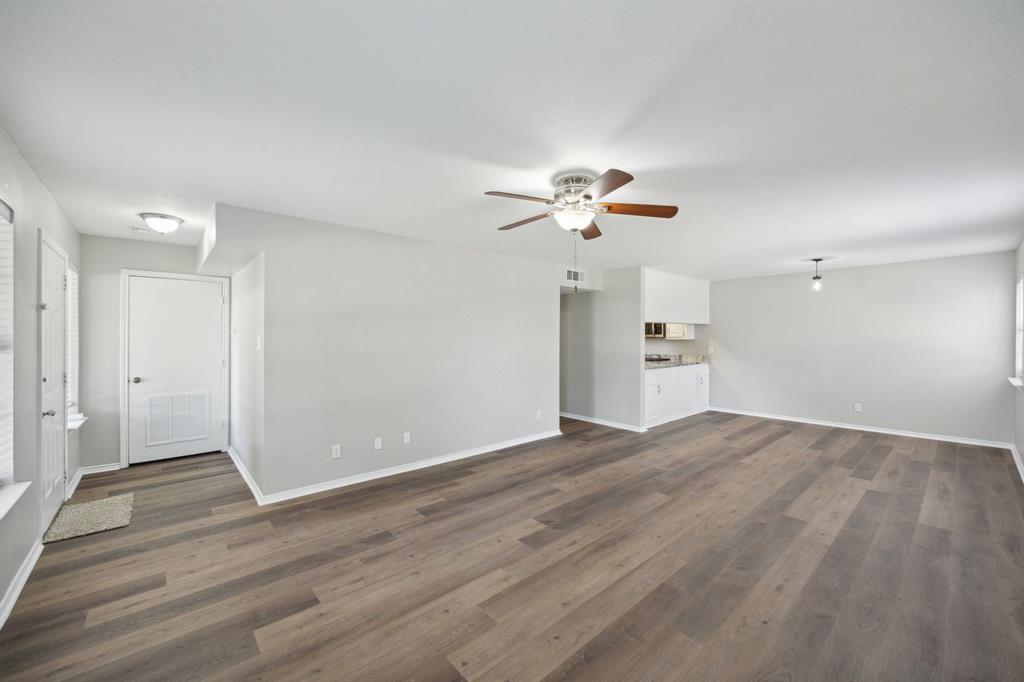 2420 Lakeview Circle McKinney, TX 75072 - Photo 22 of 25 an empty room with wooden floor and chandelier fan