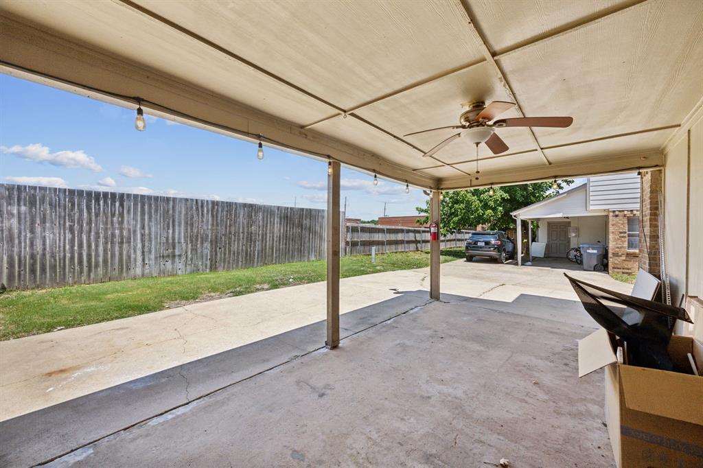 2420 Lakeview Circle McKinney, TX 75072 - Photo 25 of 25 a view of a patio with table and chairs and floor to ceiling window