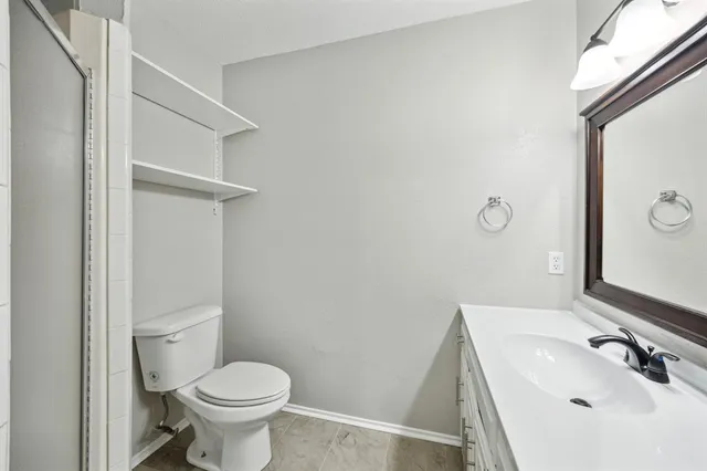 a bathroom with a sink a toilet and mirror