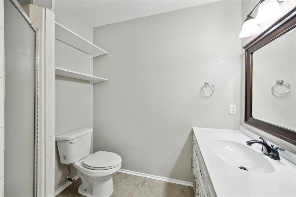 2420 Lakeview Circle McKinney, TX 75072 - Photo 6 of 25 a bathroom with a sink a toilet and mirror