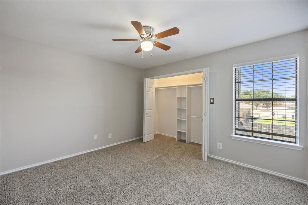 2420 Lakeview Circle McKinney, TX 75072 - Photo 7 of 25 a view of an empty room with window and a ceiling fan