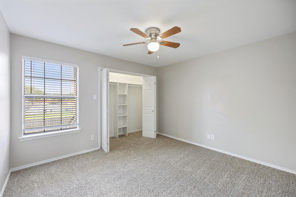 2420 Lakeview Circle McKinney, TX 75072 - Photo 8 of 25 an empty room with windows and fan